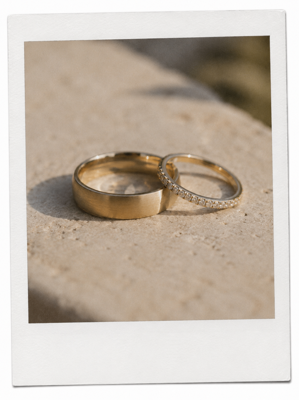 The wedding rings resting on warm stone